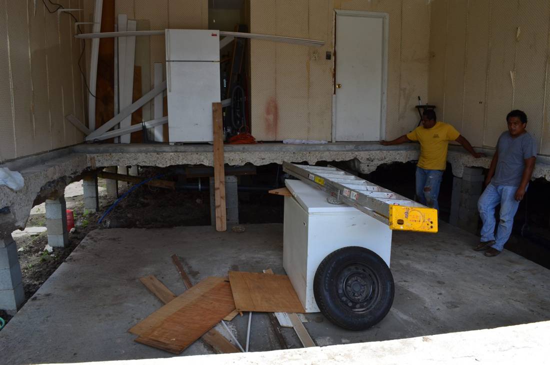 Home lifted on cribbing