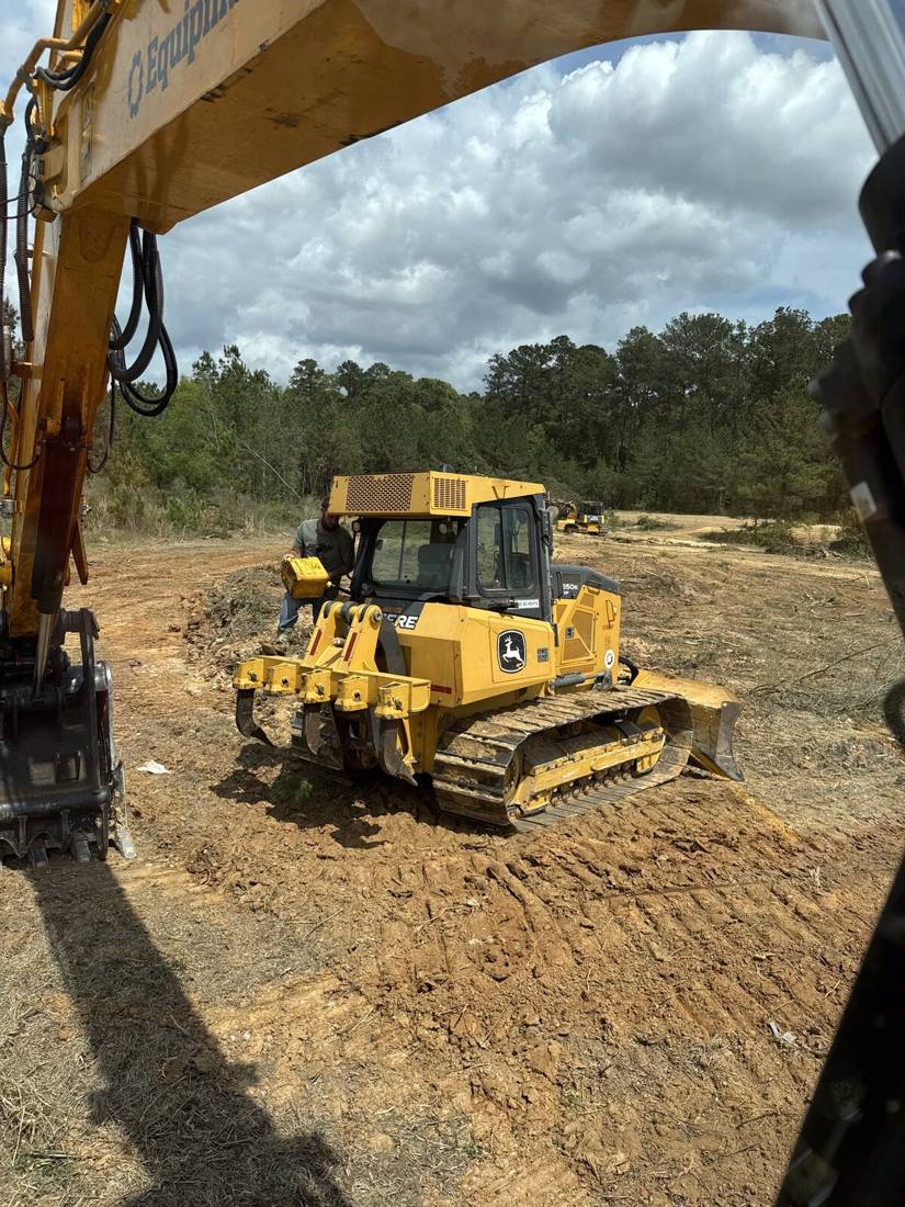 Dozer and excavator clearing land